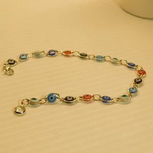 SILVER BRACELET WITH MULTICOLORED EYE LIKE STONES.